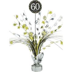 the centerpiece is decorated with silver and gold stars, streamers, and a number