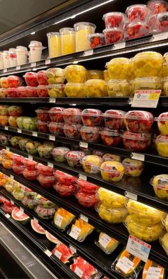 a display in a grocery store filled with lots of fruits and vegetables