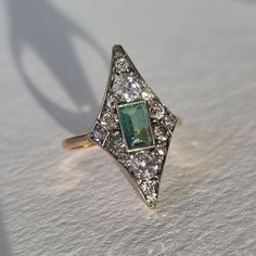 I'm happy to present this true Art Deco ring made in Finland in 1922! Made in 18k gold and a natural light green emerald set in silver together with 16 diamonds of varying cuts, old mine cuts, old European cuts, rose cut, single cut and one brilliant cut diamond (a later replacement). Made by one of Finland's absolute best jewellers, Alexander Tillander, active from 1860, started in St Petersburg but moved to Helsinki in 1917 and they are still active today. Size Ø16 mm/US 5,25-5,5 and the setti Art Deco Emerald, Emerald Set, Finnish Fashion, Old Mine Cut Diamond, True Art, Deco Ring, Art Deco Ring, Antique Art Deco, Helsinki