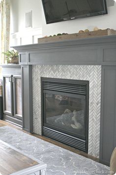 a tv mounted above a fireplace in a living room