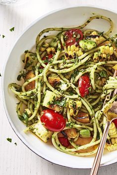 a white bowl filled with pasta and vegetables on top of a wooden table next to an instagram post