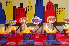 a table topped with cups filled with chips and sauces next to plates covered in napkins