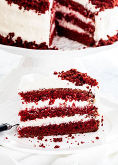 a slice of red velvet cake with white frosting