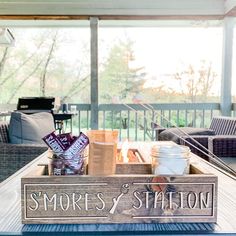 a tray that has some food in it on top of a wooden table with the words smores and station