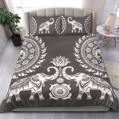 an elephant bedding set with two elephants on the front and one elephant on the back