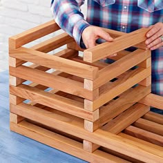 a man is placing wooden crates on top of each other