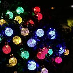 colorful christmas lights are lit up in the night time garden ornament tree decoration