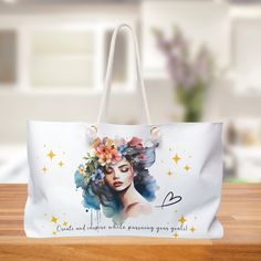 a white bag with an image of a woman's face and flowers on it