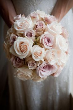 a bridal holding a bouquet of pink roses