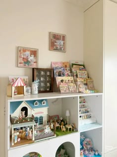 a white shelf filled with lots of toys