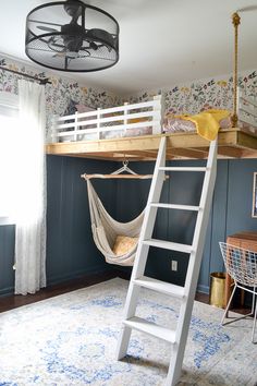 a loft bed with a hammock hanging from it's side and a ladder to the top