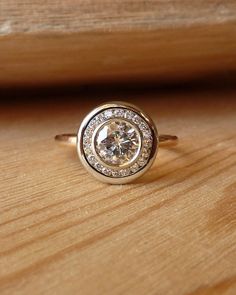 a diamond ring sitting on top of a wooden table