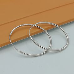 IMPORTANT **Please go through all the pictures i have posted for a listing with a ruler, on a model, on my hand, to get an exact idea of the actual size of the item. Sterling silver ear hoops. Dimensions: 1.2 x 30mm Price listed is for a PAIR of hoops. These earrings are made of 925 hypoallergenic sterling silver. Most of my pieces come with a 925 stamp. Can be packaged in a gift box. I can include a personal message from you if needed You are welcome to contact me at... bhavnakwintra1956@gmail. Sterling Silver Hoop Earrings With Simple Design, Everyday Handmade White Gold Hoop Earrings, Hoop Earrings Big, Silver Wire Earrings, Wanderlust Jewelry, Hoops Silver, Silver Eye, Earrings Big, Evil Eye Earrings