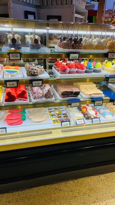 a display case in a bakery filled with lots of different types of cakes and pastries