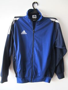 "Vintage Blue Adidas Jacket Blue Adidas Zipper Running Jacket Unisex Jogging Parka Blue Soccer Jacket Three Stripes Size Large Adidas Cardigan Label size: D 176; GB 34/36; F 16A Measurements: (lying flat) Length - 28.5\"/ 72.5 cm Shoulders: 20\"/ 51 cm Pit to pit: 22.5\"/ 57 cm Waist: 19.5\"/ 49.5 cm Sleeve: 22.5\"/ 57 cm Please check measurements to insure a proper fit. Remember to allow yourself some extra room for movement. You can compare these with something from your closet that fits you w Blue Sports Windbreaker For Fall, Blue Hooded Sports Outerwear, Blue Hooded Outerwear For Sports, Winter Blue Windbreaker With Zipper Closure, Blue Long Sleeve Outerwear With Zipper Closure, Blue Long Sleeve Outerwear With Zipper, Blue Long Sleeve Outerwear For Outdoor, Blue Sportswear Windbreaker With Pockets, Blue Sportswear Track Jacket For Fall