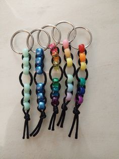 four different colored beads are attached to metal rings