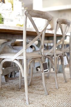 two chairs sitting on top of a carpeted floor next to a dining room table