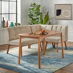 a living room with a couch, table and rug