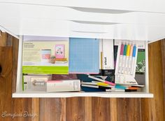 a shelf filled with assorted office supplies on top of a wooden floor