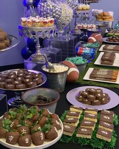 a table topped with lots of desserts and snacks