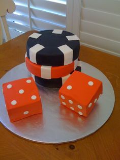 a cake with dices on it sitting on top of a table