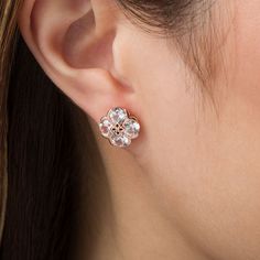 With a touch of floral charm, these lovely stud earrings are sure to become an instant favorite. Crafted in precious 10K rose gold, each pretty earring showcases a quartet of 5.0mm lab-created shimmering white sapphires. The sculpted flower-shaped center design sparkles with a diamond accent. Buffed to a brilliant luster, these post earrings secure comfortably with friction backs. Elegant Rose Gold Cluster Earrings With Prong Setting, Elegant Rose Gold Cubic Zirconia Flower Earrings, Elegant Rose Gold Flower Shape Cluster Earrings, Formal Rose Gold Flower Earrings, Rose Gold Cubic Zirconia Flower Earrings, Rose Gold Cluster Earrings For Anniversary, Elegant Rose Gold Flower Earrings For Anniversary, Classic Rose Gold Flower Shaped Jewelry, Fine Jewelry Rose Gold Cluster Earrings With Cubic Zirconia