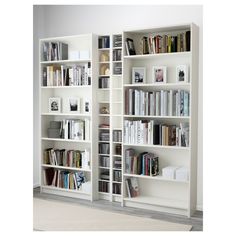 two white bookshelves filled with lots of books