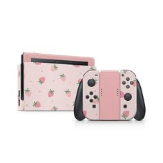 two nintendo wii game controllers in pink with strawberrys on the back and black handles