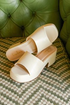 The Lulus Etain Bone Platform Slide Sandals are the easiest way to add a chic feature to any look! Smooth faux leather shapes these super trendy sandals that feature a square toe bed (atop a 1.25"" toe platform) and an extra wide toe strap. A chunky block heel completes the simple and stylish slide-on design. 2. 5" block heel. Lightly cushioned insole. Rubber sole has nonskid markings. Man made materials. Imported. Lulus | Etain Bone Platform Slide Sandal Heels | Size 7.5. White Sandals Platform, Beige Platform Sandals, Summer Block Heel Faux Leather Mules, Summer Faux Leather Block Heel Mules, Summer Faux Leather Mules With Block Heel, Trendy Leather Block Heels For Summer, Cushioned Footbed Sandals With Square Toe For Summer, Summer Leather Block Heels With Cushioned Footbed, Summer Open Heel Block Heels With Cushioned Footbed