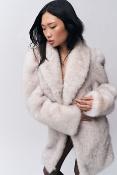 Wrap yourself in luxury with our Roxie Faux Fur Coat. This stylish piece features a plush, soft faux fur that adds a touch of glamour to any outfit. With its chic silhouette and elegant design, the Roxie Coat is perfect for elevating your look during colder months. Composition: 100% Polyester Meishing is wearing a size XS and is 5'10" with a 34" bust, 34" hips, and 24" waist Glamorous Faux Fur Outerwear With Faux Fur Lining, Glamorous Faux Fur Lined Outerwear, Glamorous Faux Fur Outerwear, Glamorous Faux Fur Coat For Winter, Glamorous Faux Fur Coat With Fur Trim, Glamorous Faux Fur Coat With Trim, Glamorous Faux Fur Coat, Evening Faux Fur Coat For Fall, Fall Evening Faux Fur Coat