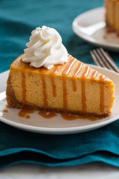 a slice of pumpkin cheesecake with whipped cream on top