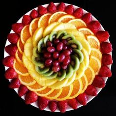 a plate filled with sliced fruit and oranges