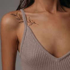 a woman with a tattoo on her shoulder