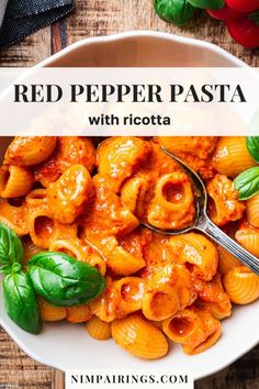 red pepper pasta with ricotta in a white bowl on top of a wooden table