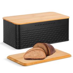 a loaf of bread sitting on top of a cutting board next to a slice of bread