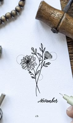 a drawing of a flower with the word november written in black ink on a white paper