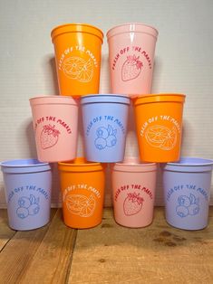 there are many cups that have different designs on them, all in different colors and sizes