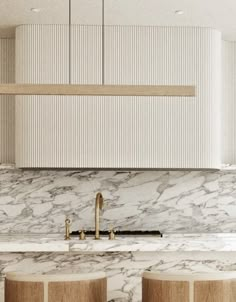 a kitchen with marble counter tops and stools