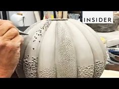 a man is working on a vase with holes in it