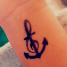 an anchor tattoo is shown on the side of a woman's right arm,