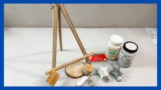 an assortment of crafting supplies sitting on a white table top with blue border around them