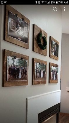 the wall is decorated with pictures and wreaths on it's sides, along with a fireplace mantel