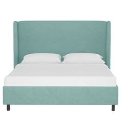 a bed with white sheets and blue headboard on it's side, in front of a white background