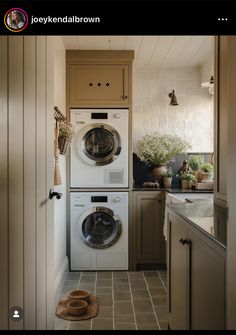 a washer and dryer sitting in a kitchen next to each other on top of a tile floor