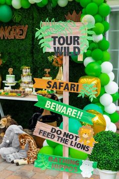 a safari themed birthday party with balloons and signs