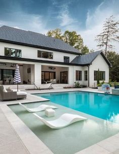 a large pool in front of a white house