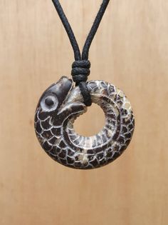 This ouroboros is hand-carved by myself from natural stone called soft marble. It's carved on the both sides with deatails. The size of the pendant is approximately 3.5 x 3.5 x 1cm (1.3 x 1.3 x 0.3inches ).  The pendant comes with free adjustable black waxed cotton cord.  Not only are these pendants a beautiful thing to wear as part of your jewellery collection, but they are also very pleasing to the touch. The weight and smoothness of the hand carved stone makes these pendants a tactile comfort Soft Marble, Serpent Necklace, Hand Carved Stone, Carved Stone, Infinity Symbol, Ancient Symbols, Circle Of Life, By Myself, Stone Carving