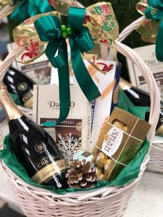 a basket filled with wine and chocolates on top of a table next to other items