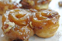 several donuts with icing and nuts on them