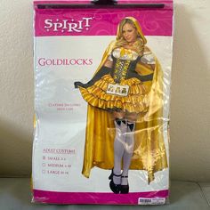 a woman in a costume that is yellow and has black trim on the bottom half of her skirt